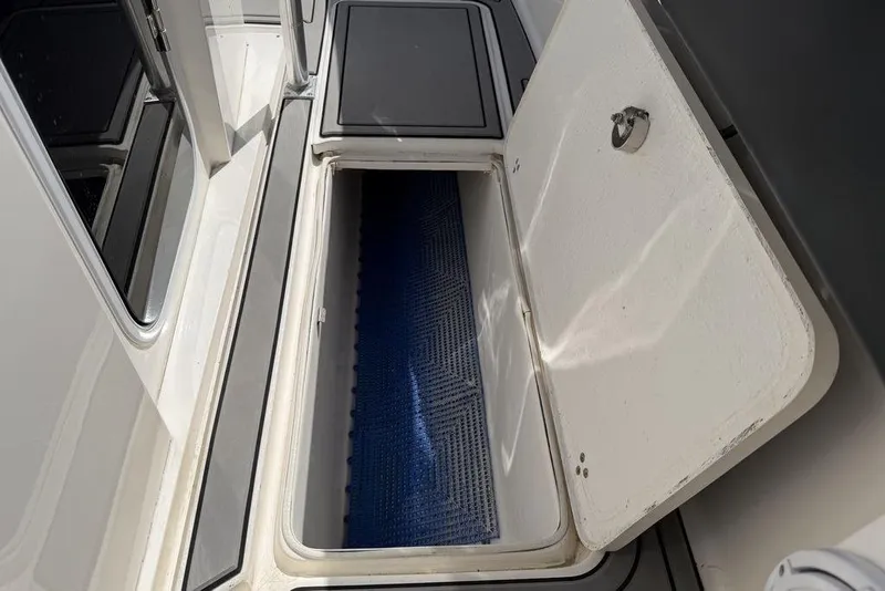 Slide: The Image of Open storage compartment on 2004 Fountain Bluewater 34 CC boat deck. - 23