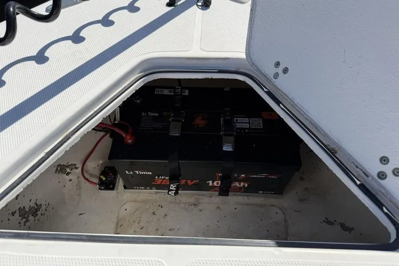Slide: The Image of Battery compartment of a 2004 Fountain Bluewater 34 CC boat, featuring Li Time batteries. - 26