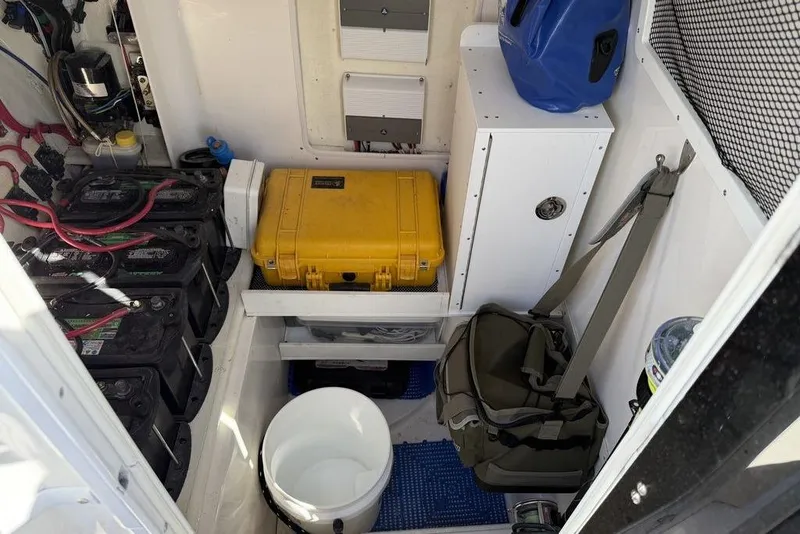 Slide: The Image of Interior storage of 2004 Fountain Bluewater 34 CC boat with batteries and equipment. - 27
