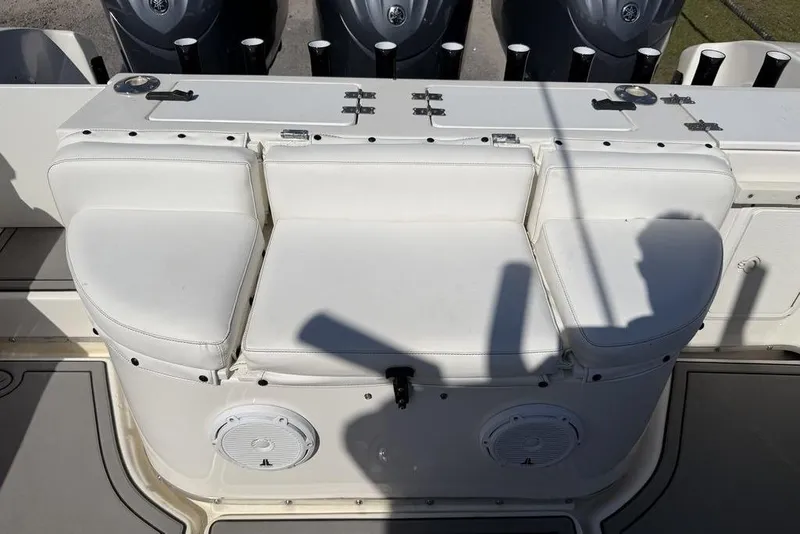 Slide: The Image of White seating area on a 2004 Fountain Bluewater 34 CC boat with speakers. - 28