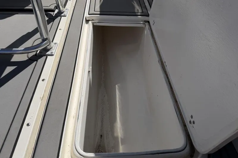Slide: The Image of Open storage compartment on 2004 Fountain Bluewater 34 CC boat deck. - 29