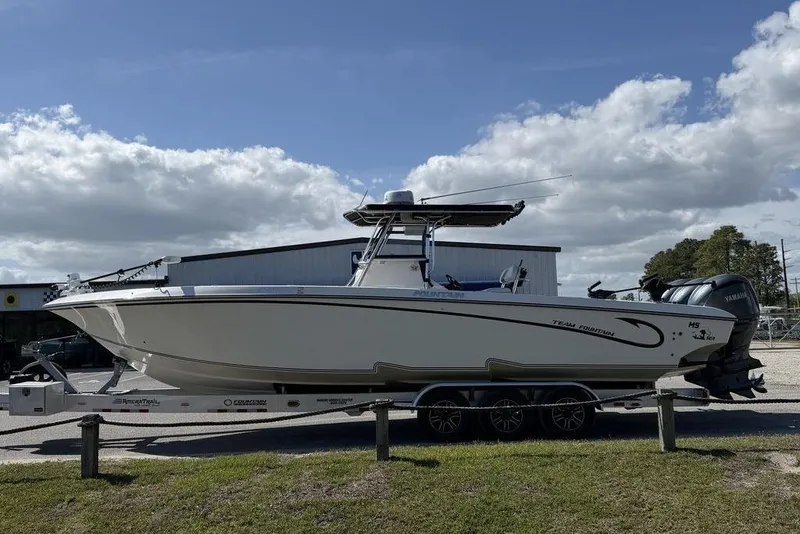 Slide: The Image of 2004 Fountain Bluewater 34 CC boat on trailer under cloudy sky. - 3