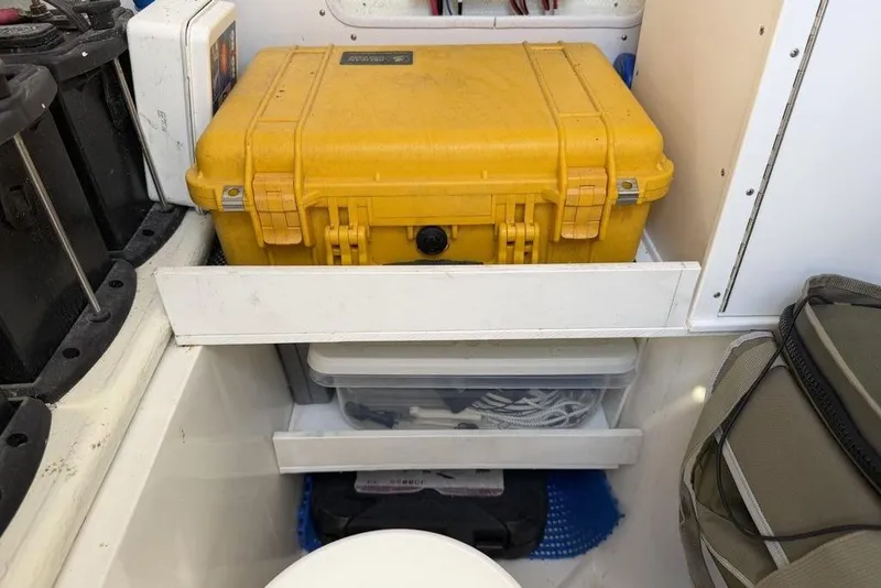 Slide: The Image of Storage compartment on a 2004 Fountain Bluewater 34 CC boat with yellow case and gear. - 30