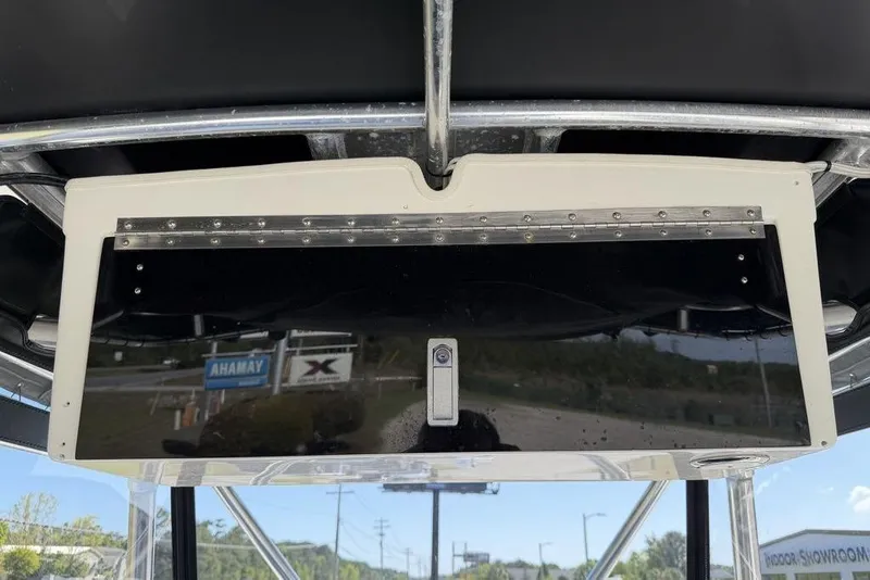 Slide: The Image of 2004 Fountain Bluewater 34 CC boat console with reflective panel and outdoor showroom view. - 33