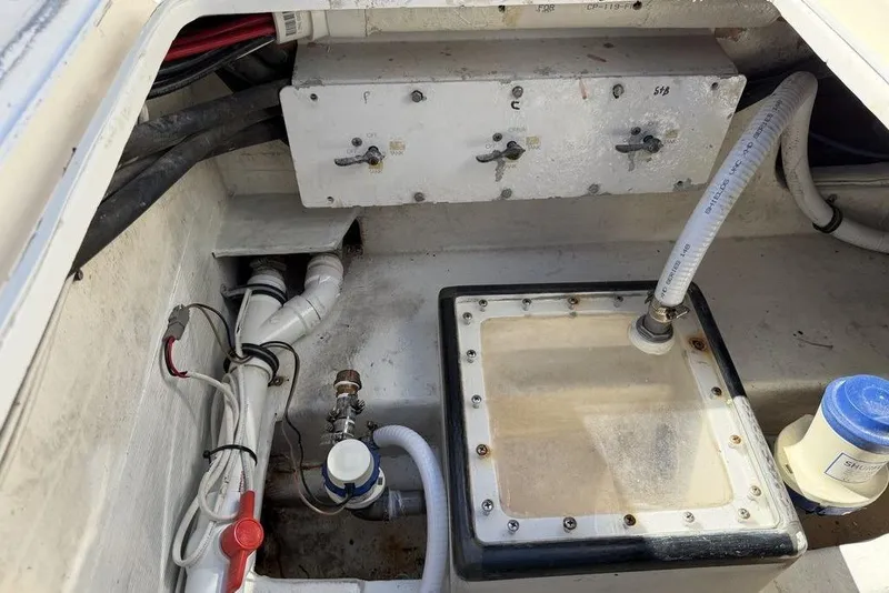 Slide: The Image of 2004 Fountain Bluewater 34 CC boat interior showing plumbing and wiring components. - 36