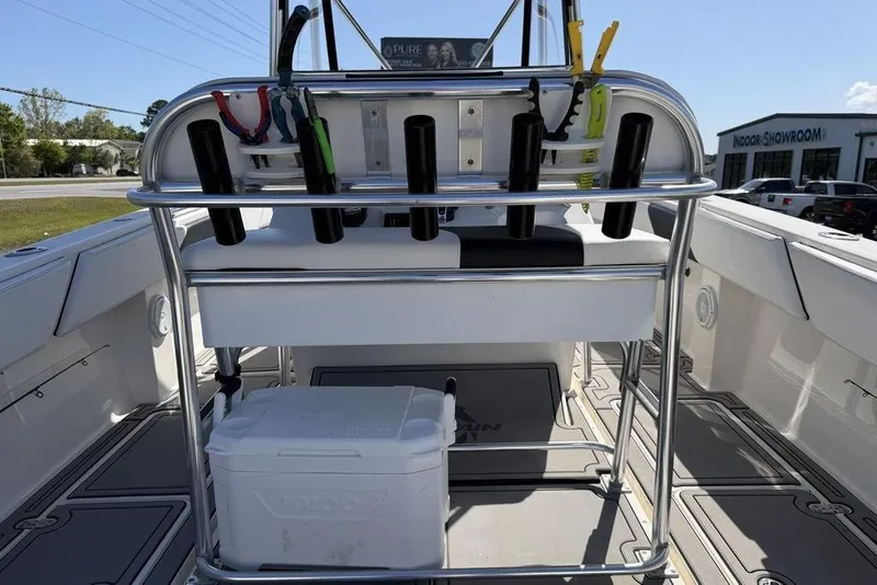 Slide: The Image of 2004 Fountain Bluewater 34 CC boat interior with rod holders and cooler. - 38