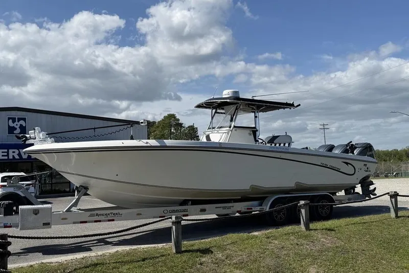 Slide: The Image of 2004 Fountain Bluewater 34 CC boat on trailer under cloudy sky. - 4