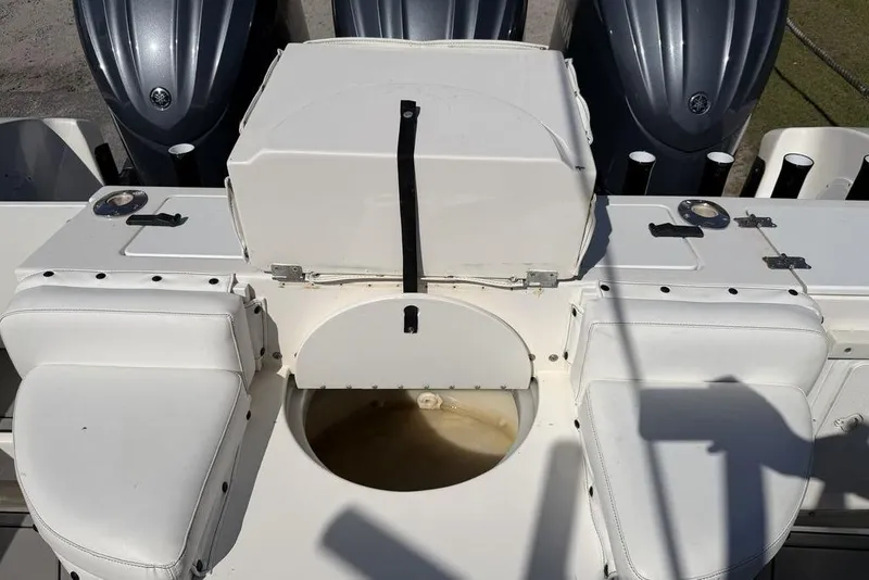 Slide: The Image of 2004 Fountain Bluewater 34 CC boat interior with seating and engine view. - 40
