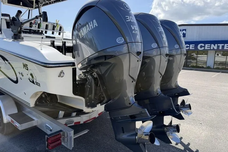 Slide: The Image of 2004 Fountain Bluewater 34 CC boat with triple Yamaha 300 V6 engines at service center. - 41