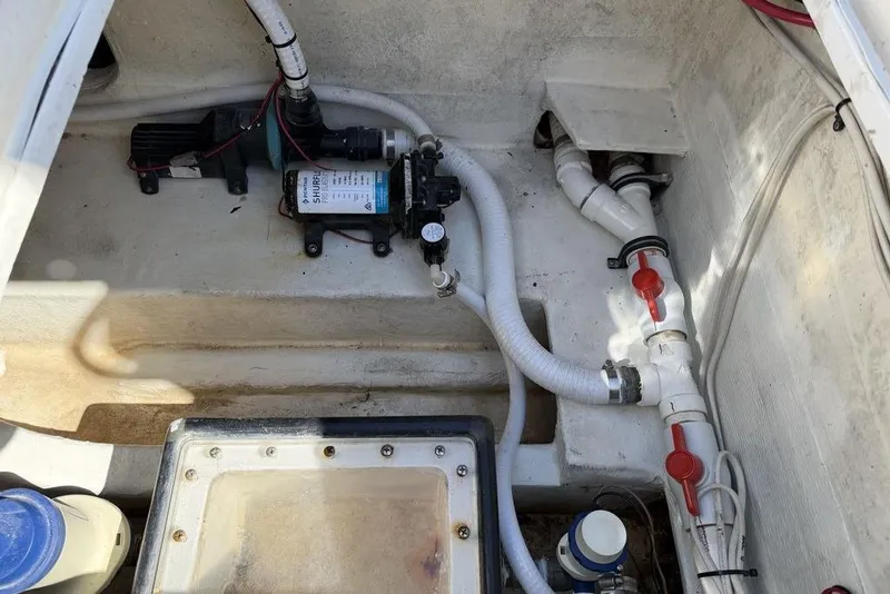 Slide: The Image of 2004 Fountain Bluewater 34 CC boat plumbing system with pump and valves. - 43