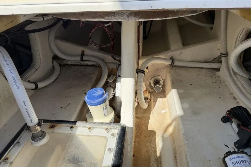 Slide: The Image of 2004 Fountain Bluewater 34 CC boat interior showing plumbing and wiring components. - 44