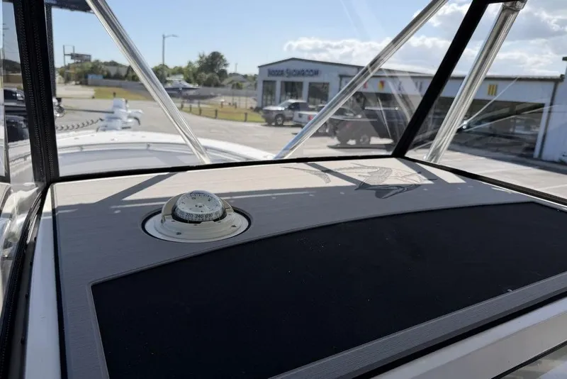 Slide: The Image of 2004 Fountain Bluewater 34 CC boat dashboard with compass, viewed through windshield. - 45