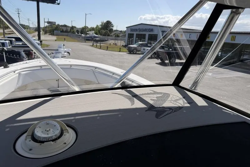 Slide: The Image of 2004 Fountain Bluewater 34 CC boat dashboard with compass, viewed from cockpit. - 46