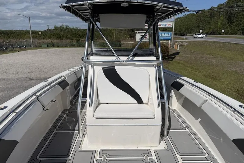 Slide: The Image of 2004 Fountain Bluewater 34 CC boat interior with seating and T-top, parked outdoors. - 48