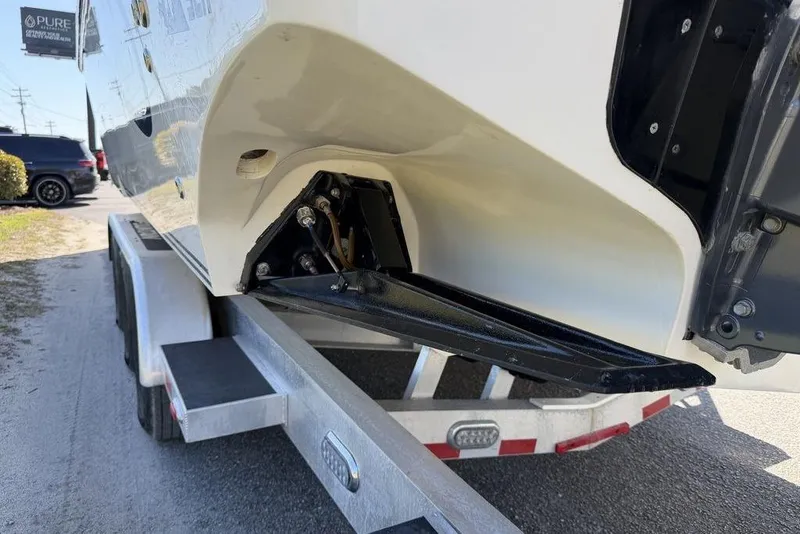 Slide: The Image of 2004 Fountain Bluewater 34 CC boat on trailer, showing hull and trim tab details. - 50