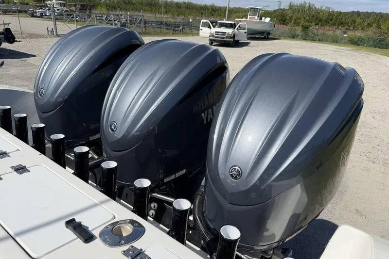 Slide: The Image of Triple Yamaha outboard engines on a 2004 Fountain Bluewater 34 CC boat. - 51