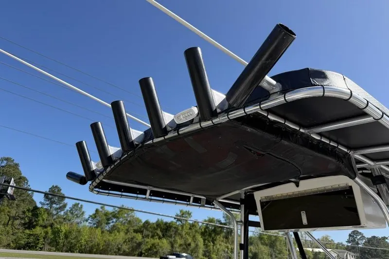 Slide: The Image of T-top rod holders on a 2004 Fountain Bluewater 34 CC boat under clear blue sky. - 53