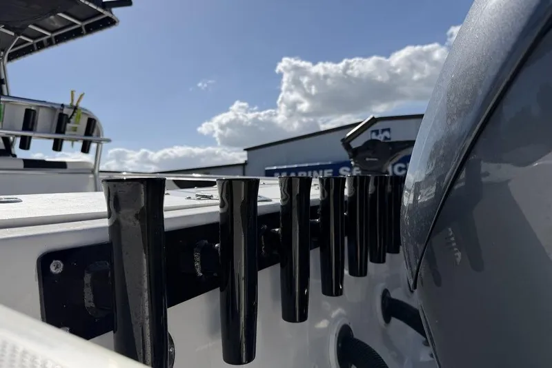 Slide: The Image of 2004 Fountain Bluewater 34 CC boat with rod holders, under a clear sky. - 58