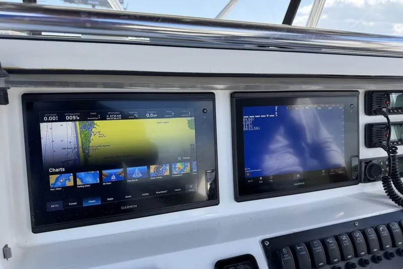 Slide: The Image of Dashboard of a 2004 Fountain Bluewater 34 CC with Garmin navigation displays. - 59