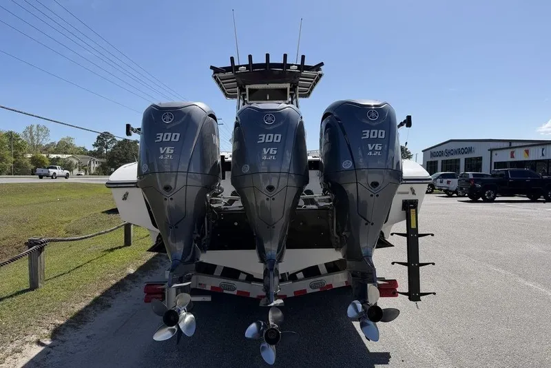 Slide: The Image of 2004 Fountain Bluewater 34 CC with triple Yamaha 300 V6 engines, parked outdoors. - 64