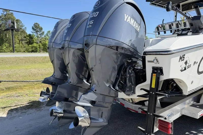 Slide: The Image of Triple Yamaha outboard engines on a 2004 Fountain Bluewater 34 CC boat. - 66
