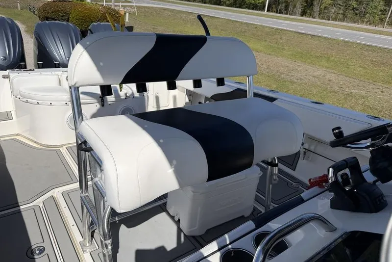 Slide: The Image of 2004 Fountain Bluewater 34 CC boat interior with dual seats and steering console. - 7