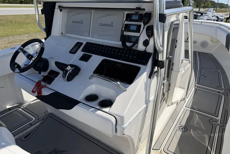 Slide: The Image of 2004 Fountain Bluewater 34 CC boat cockpit with Garmin navigation system and steering wheel. - 79