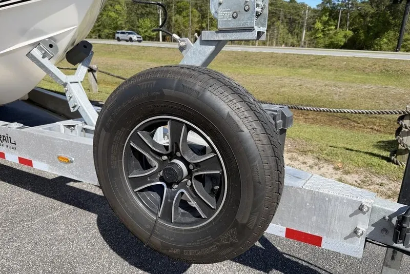 Slide: The Image of Trailer wheel of a 2004 Fountain Bluewater 34 CC boat on a sunny day. - 80