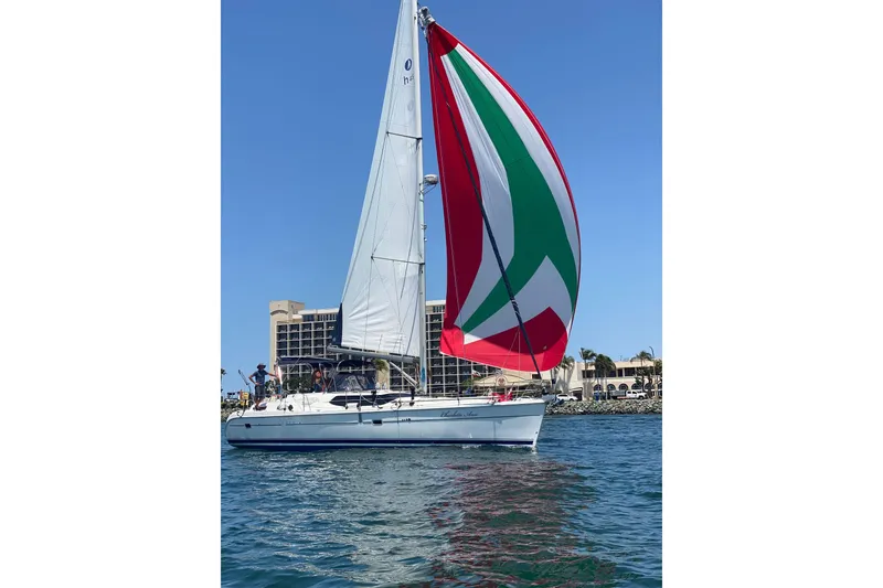 The Image of 2006 Hunter 45 CC sailboat with colorful spinnaker on open water. - 0