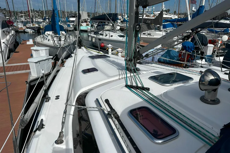 Slide: The Image of Sailboat deck view of 2006 Hunter 45 CC in marina, surrounded by other boats. - 1