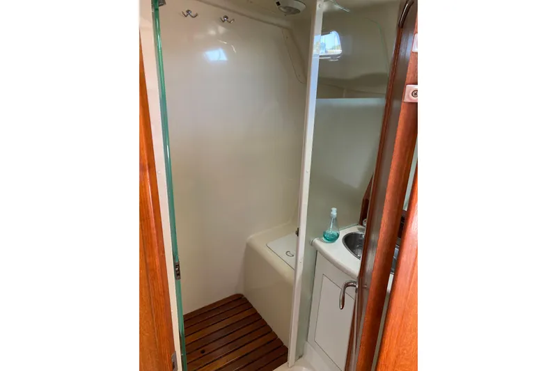 Slide: The Image of Compact bathroom in 2006 Hunter 45 CC yacht with wooden flooring and sink. - 11