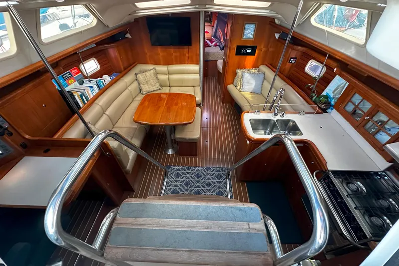 Slide: The Image of Interior of 2006 Hunter 45 CC yacht with cozy seating, kitchen, and wood finish. - 12