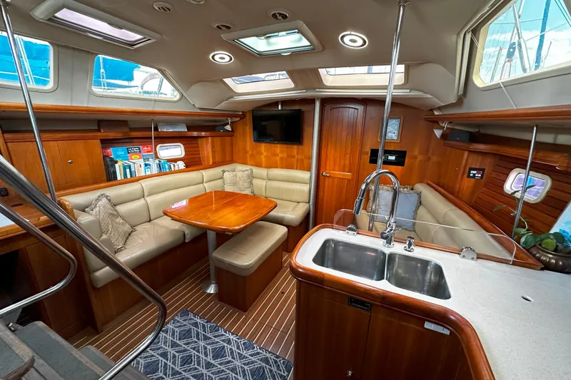 Slide: The Image of Luxurious 2006 Hunter 45 CC yacht interior with elegant wood finish and spacious seating area. - 15
