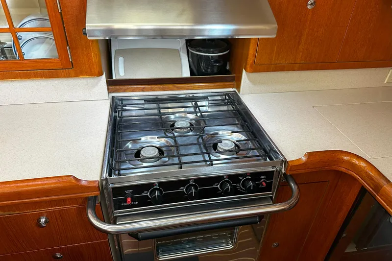 Slide: The Image of Stainless steel stove in 2006 Hunter 45 CC yacht kitchen with wooden cabinetry. - 24