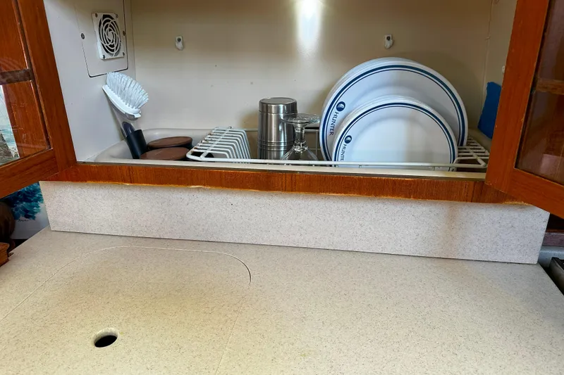 Slide: The Image of Kitchen area in a 2006 Hunter 45 CC yacht with dish rack and utensils. - 31