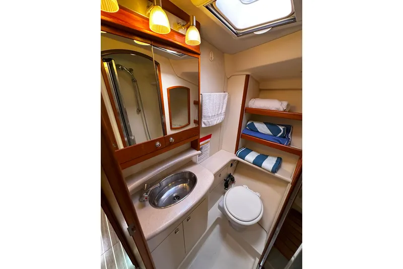 Slide: The Image of Luxurious 2006 Hunter 45 CC yacht bathroom with sink, toilet, and shelving. - 36