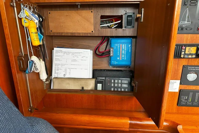 Slide: The Image of 2006 Hunter 45 CC sailboat electrical panel with keys and documents. - 44