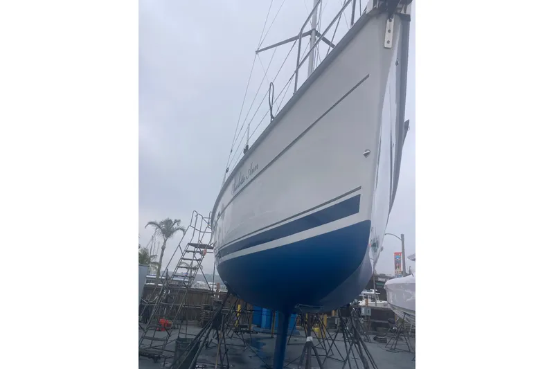 Slide: The Image of Hunter 45 CC sailboat from 2006 on dry dock, showcasing its sleek hull design. - 49