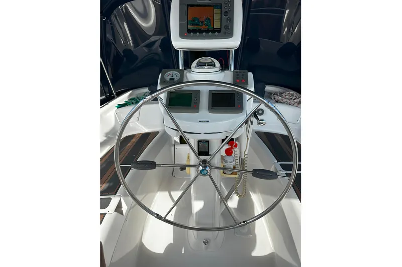 Slide: The Image of Steering wheel and controls of a 2006 Hunter 45 CC sailboat cockpit. - 55