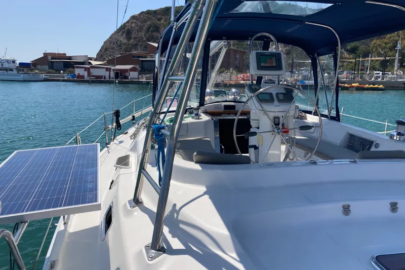 Slide: The Image of Sailboat Hunter 45 CC 2006 with solar panel, docked in a scenic marina. - 60