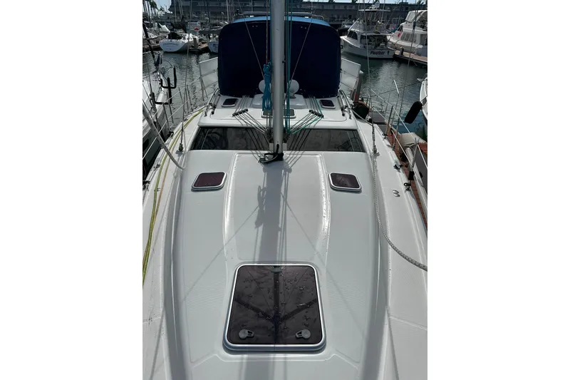Slide: The Image of 2006 Hunter 45 CC sailboat deck view in marina, showcasing sleek design and rigging. - 61
