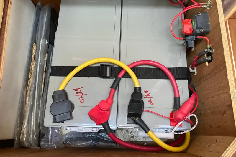 Slide: The Image of Battery compartment of a 2006 Hunter 45 CC sailboat with cables and connectors. - 67