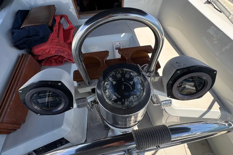 Slide: The Image of 1989 Ericson Sloop cockpit with compass and navigation instruments. - 11