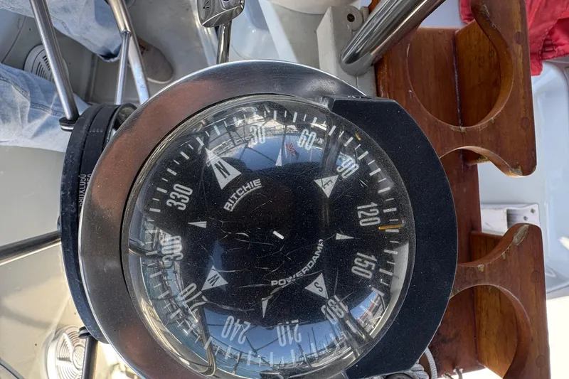 Slide: The Image of Compass on 1989 Ericson Sloop sailboat, showing navigation directions. - 12