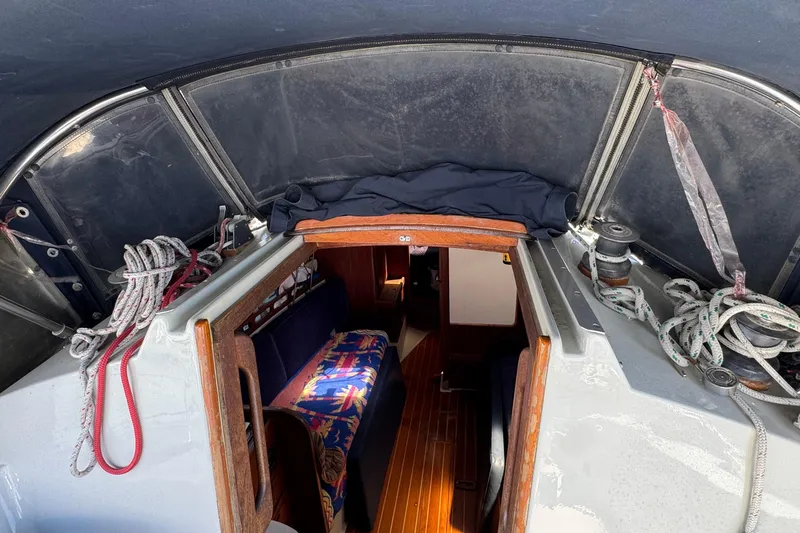 Slide: The Image of 1989 Ericson Sloop interior view with ropes and colorful seating. - 20