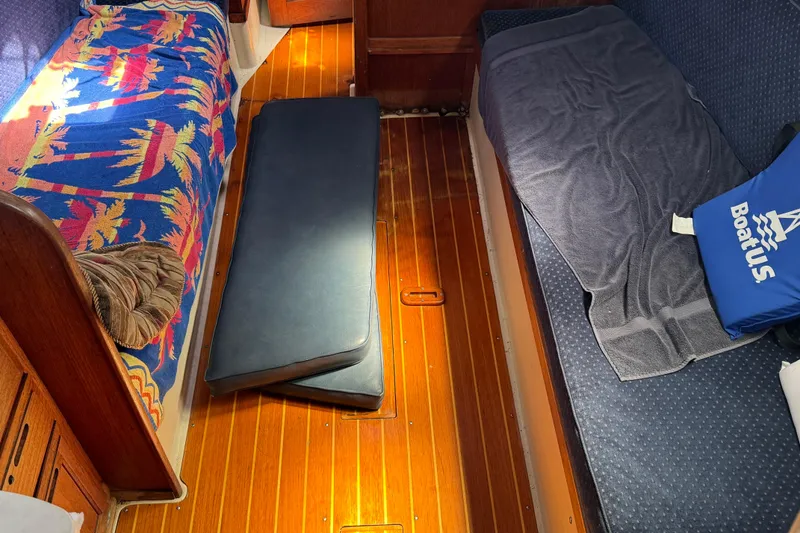 Slide: The Image of Interior of 1989 Ericson Sloop with colorful bedding and wooden flooring. - 21