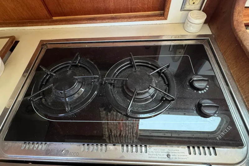 Slide: The Image of Gas stove on 1989 Ericson Sloop yacht, featuring dual burners and control knobs. - 26