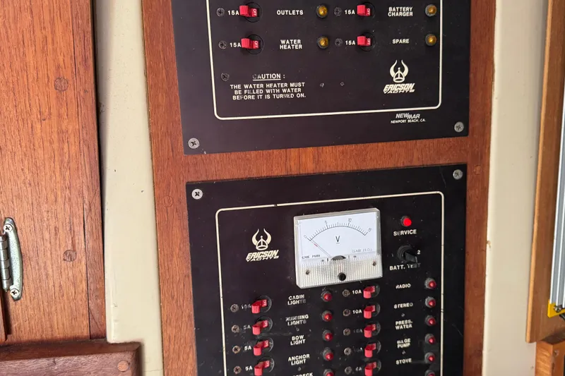 Slide: The Image of Electrical panel on a 1989 Ericson Sloop, featuring switches and a voltmeter. - 28