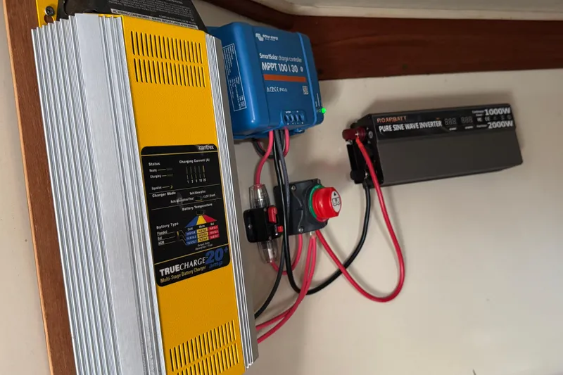 Slide: The Image of Electrical system setup on a 1989 Ericson Sloop, featuring charger and inverter. - 29