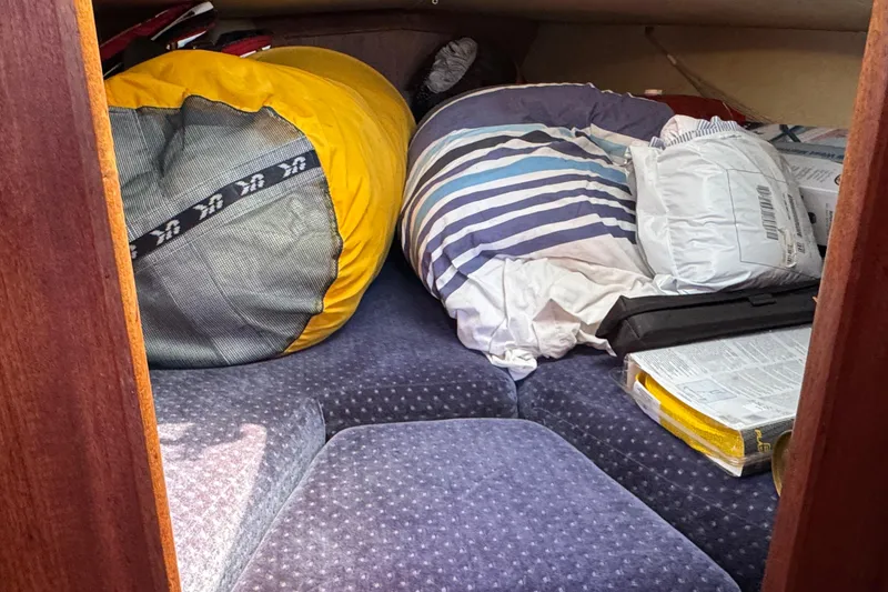 Slide: The Image of Cozy cabin interior of 1989 Ericson Sloop with cushions and storage items. - 37